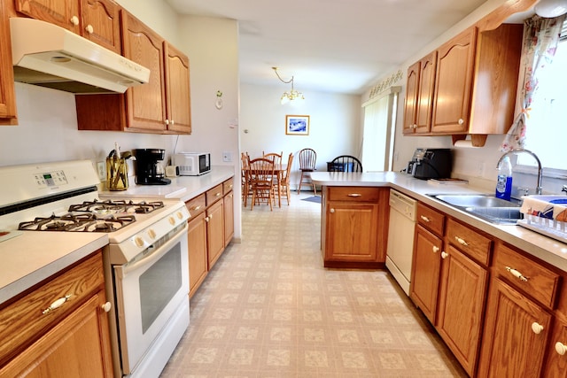 62 Jernegan Ave, Edgartown, MA 02539 - kitchen with white appliances, under cabinet range hood, a sink, light floors, and light countertops