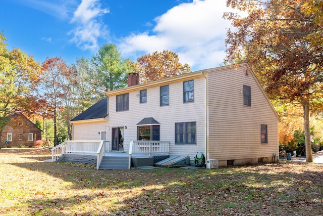 view of front of house with a wooden deck and a front lawn