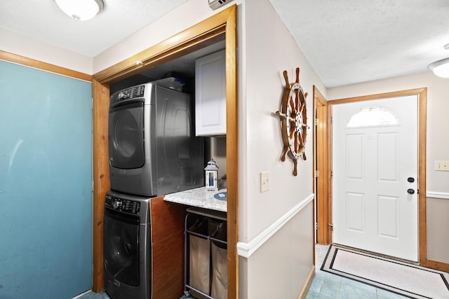 laundry room with stacked washer and clothes dryer