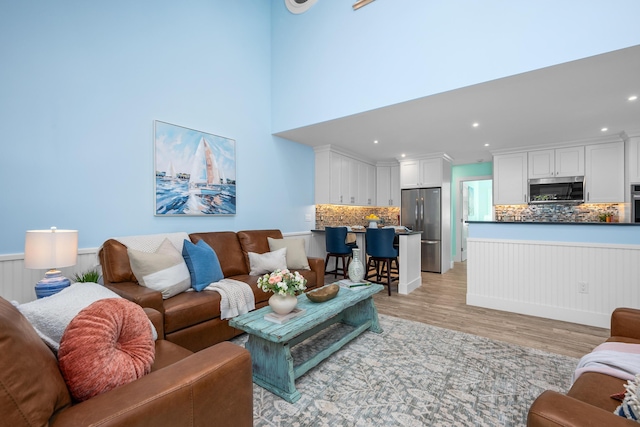 290 Fletcher Ln, Brewster, MA 02631 - living room with light wood-style floors, a wainscoted wall, and recessed lighting