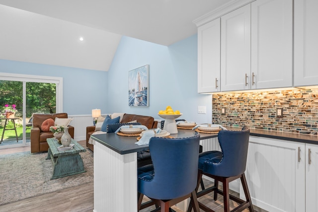 290 Fletcher Ln, Brewster, MA 02631 - dining area featuring wood finished floors, lofted ceiling, wainscoting, and recessed lighting