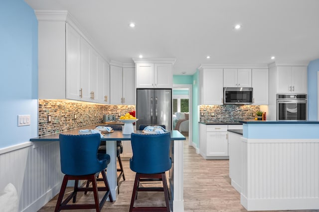 290 Fletcher Ln, Brewster, MA 02631 - kitchen with stainless steel appliances, backsplash, white cabinetry, dark countertops, and recessed lighting