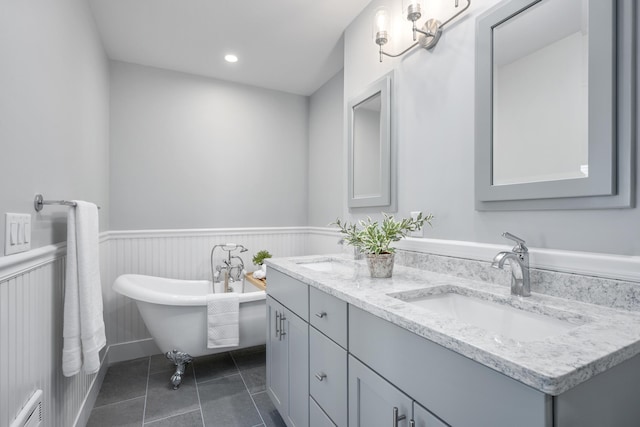 290 Fletcher Ln, Brewster, MA 02631 - bathroom featuring double vanity, a wainscoted wall, a freestanding bath, tile patterned floors, and recessed lighting