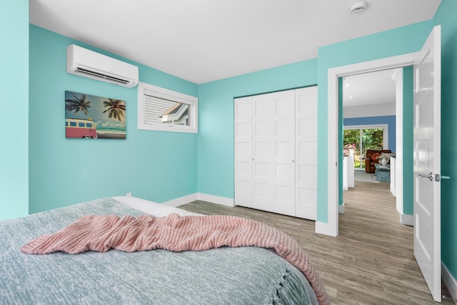 290 Fletcher Ln, Brewster, MA 02631 - bedroom featuring an AC wall unit, wood finished floors, and a closet
