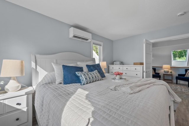 290 Fletcher Ln, Brewster, MA 02631 - bedroom with a wall mounted AC and wood finished floors