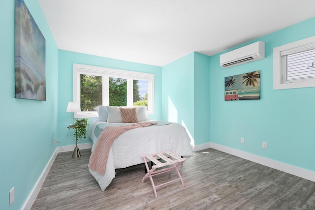 290 Fletcher Ln, Brewster, MA 02631 - bedroom with a wall mounted AC and wood finished floors