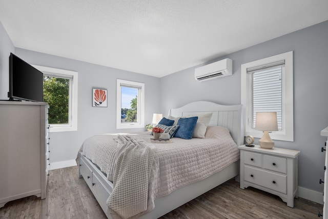 290 Fletcher Ln, Brewster, MA 02631 - bedroom featuring a wall mounted air conditioner and wood finished floors