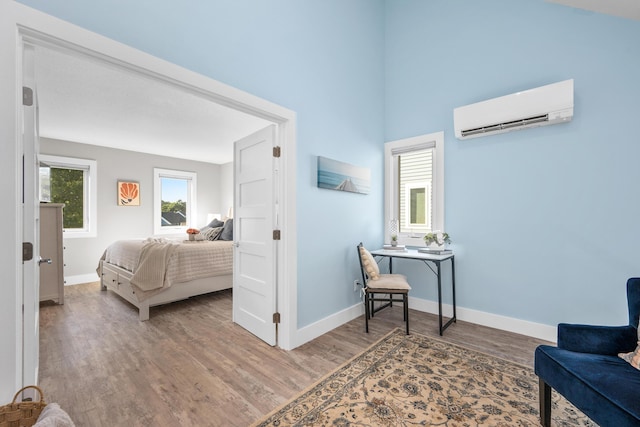 290 Fletcher Ln, Brewster, MA 02631 - bedroom featuring a wall mounted AC and wood finished floors