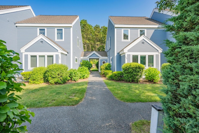 290 Fletcher Ln, Brewster, MA 02631 - view of front facade with a front lawn and roof with shingles