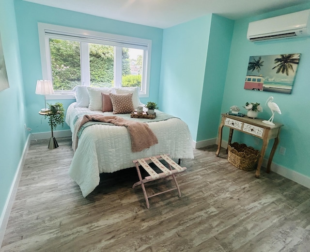 290 Fletcher Ln, Brewster, MA 02631 - bedroom featuring a wall mounted air conditioner and wood finished floors