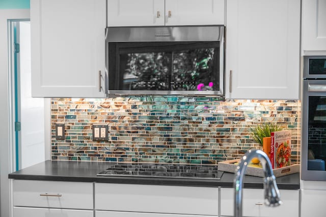 290 Fletcher Ln, Brewster, MA 02631 - kitchen with decorative backsplash, black electric cooktop, white cabinets, and dark countertops