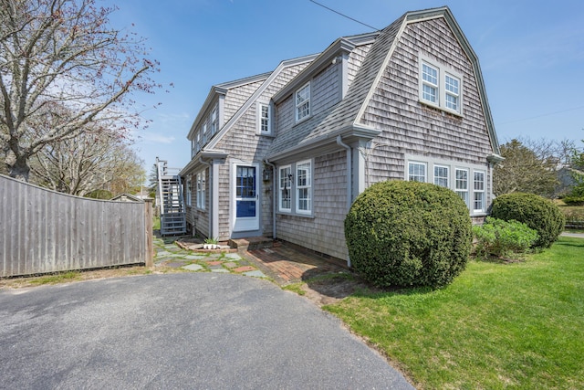 402 Old Wharf Rd, Dennis Port, MA 02639 - view of home's exterior featuring a lawn, a shingled roof, and fence