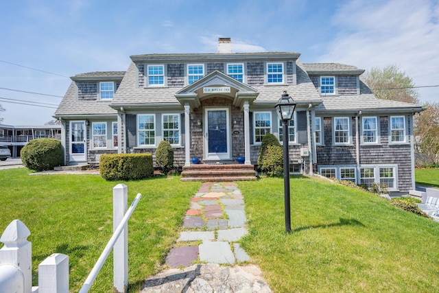 402 Old Wharf Rd, Dennis Port, MA 02639 - shingle-style home featuring roof with shingles, a chimney, and a front yard