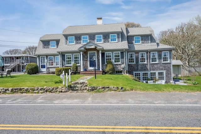 402 Old Wharf Rd, Dennis Port, MA 02639 - view of front facade featuring a chimney, roof with shingles, and a front lawn