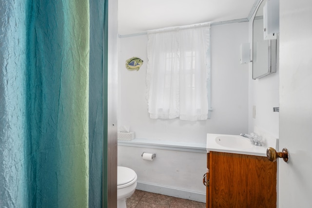 full bath with toilet, baseboards, vanity, and tile patterned floors