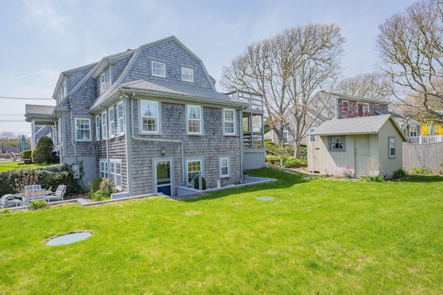 402 Old Wharf Rd, Dennis Port, MA 02639 - rear view of property featuring a shingled roof and a lawn