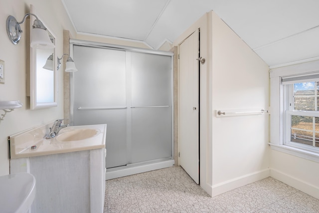 bathroom with lofted ceiling, a shower stall, vanity, baseboards, and tile patterned floors