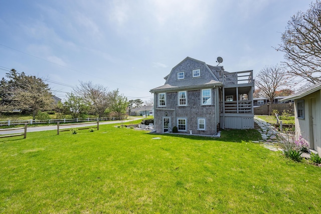 402 Old Wharf Rd, Dennis Port, MA 02639 - rear view of house featuring a gambrel roof, a yard, fence, and a wooden deck