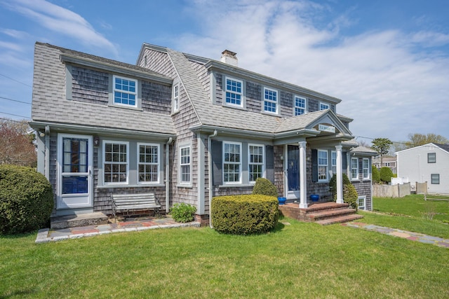 402 Old Wharf Rd, Dennis Port, MA 02639 - view of front of home with a chimney, roof with shingles, and a front lawn