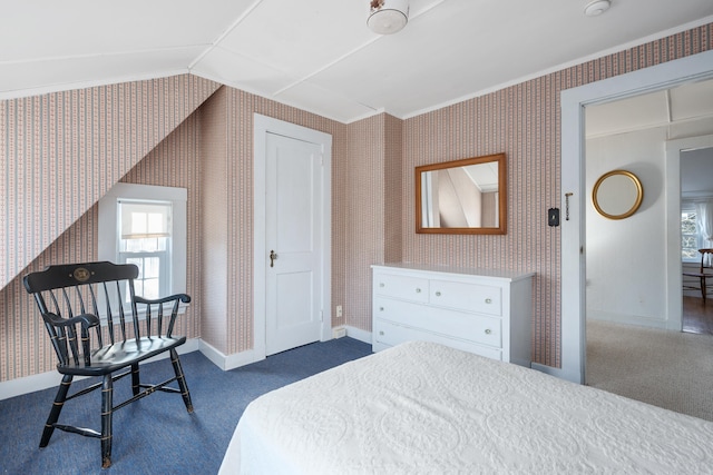 bedroom with lofted ceiling, baseboards, and wallpapered walls