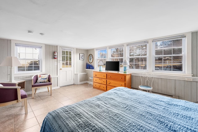 bedroom with baseboards and light tile patterned flooring