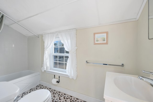 bathroom featuring shower / washtub combination, toilet, vaulted ceiling, vanity, and baseboards