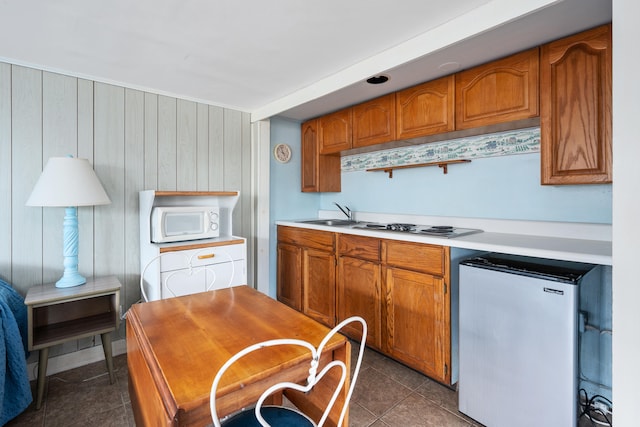 402 Old Wharf Rd, Dennis Port, MA 02639 - kitchen with freestanding refrigerator, dark tile patterned flooring, brown cabinetry, white microwave, and light countertops
