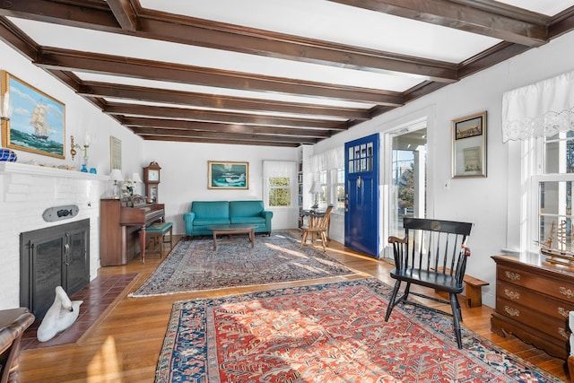 402 Old Wharf Rd, Dennis Port, MA 02639 - living area featuring a fireplace, beamed ceiling, and wood finished floors