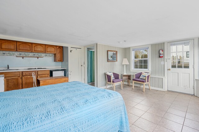 bedroom featuring light tile patterned floors and a sink