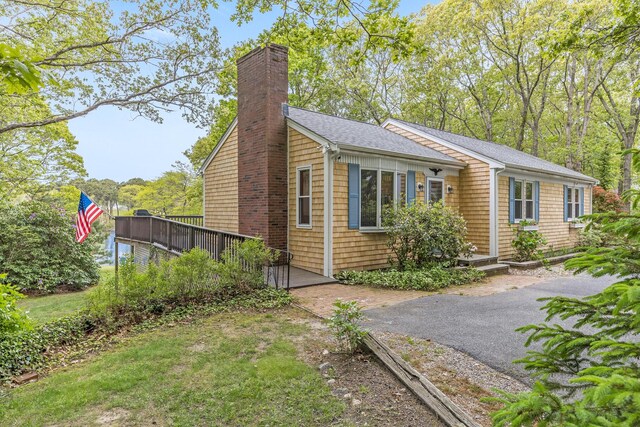 51 Wianno Cir, Osterville, MA 02655 - view of front of property with a chimney, roof with shingles, and a deck