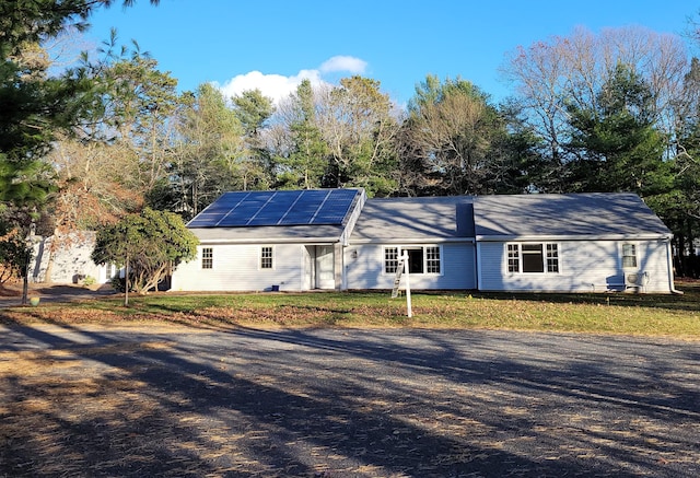 single story home featuring solar panels