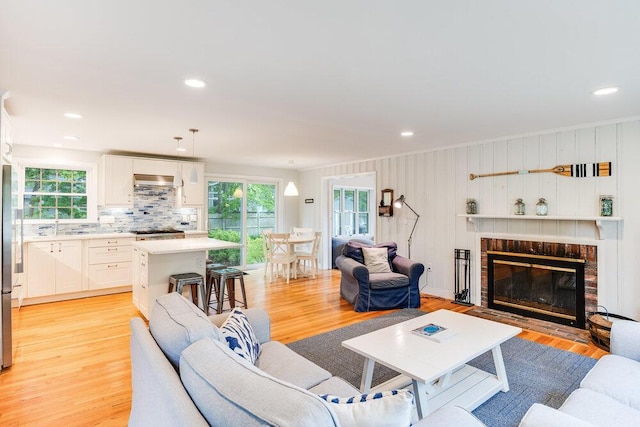 22 Emerson Rd, East Falmouth, MA 02536 - living area featuring light wood-style floors, a fireplace, recessed lighting, and crown molding