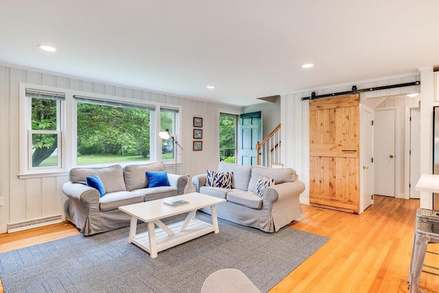 22 Emerson Rd, East Falmouth, MA 02536 - living area with a barn door, baseboard heating, light wood-style floors, recessed lighting, and crown molding