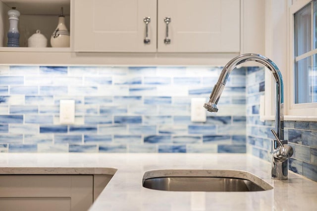 22 Emerson Rd, East Falmouth, MA 02536 - kitchen view of backsplash, light stone countertops, and white cabinets