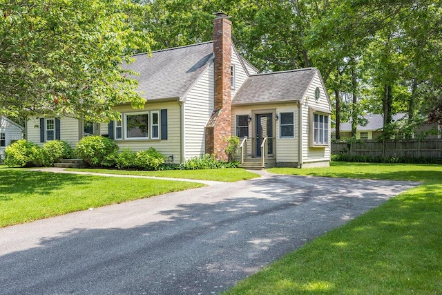 22 Emerson Rd, East Falmouth, MA 02536 - view of front of house featuring roof with shingles and a chimney