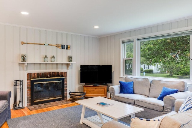 22 Emerson Rd, East Falmouth, MA 02536 - living area with crown molding, a brick fireplace, wood finished floors, and recessed lighting