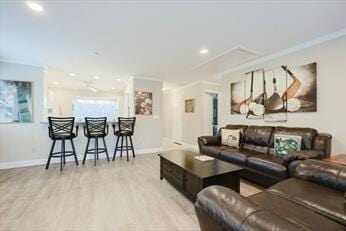 living area featuring recessed lighting, wood finished floors, baseboards, and ornamental molding