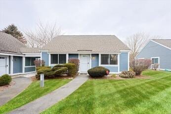 view of front of home with aphalt driveway, an attached garage, and a front yard