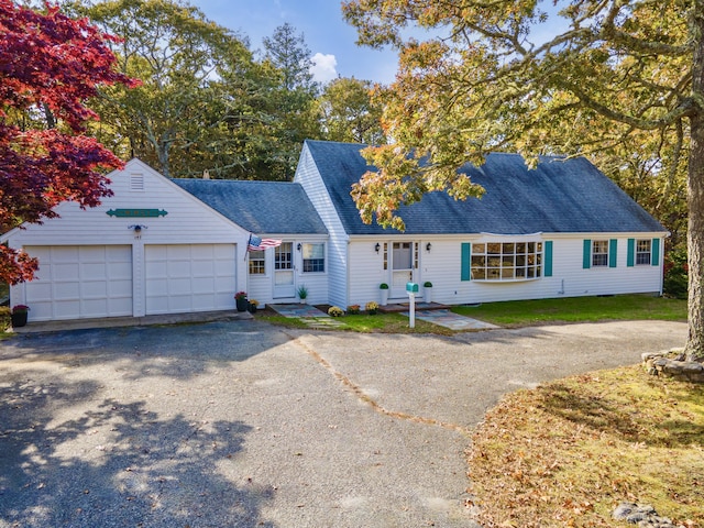 cape cod home with a garage