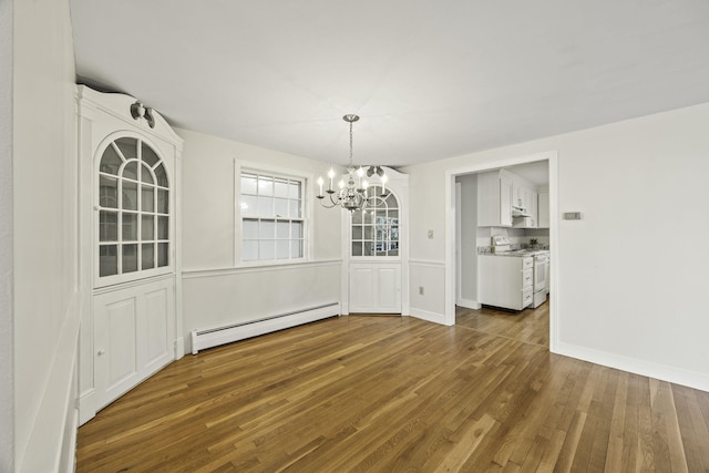 unfurnished dining area with an inviting chandelier, dark hardwood / wood-style floors, and baseboard heating