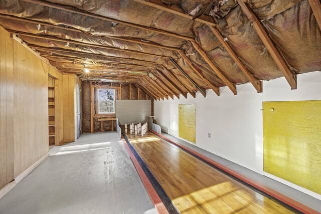 bedroom with a baseboard heating unit and wood-type flooring