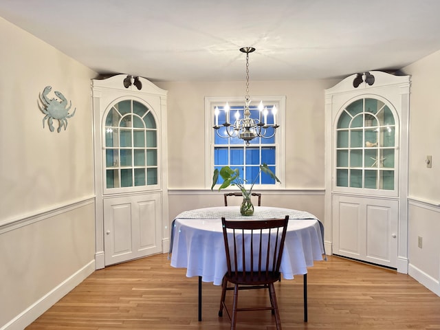 dining space with a notable chandelier, light wood-type flooring, and breakfast area