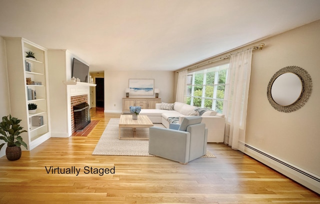 living room with light wood-type flooring, a baseboard heating unit, and a brick fireplace