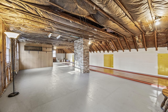 basement featuring wood walls