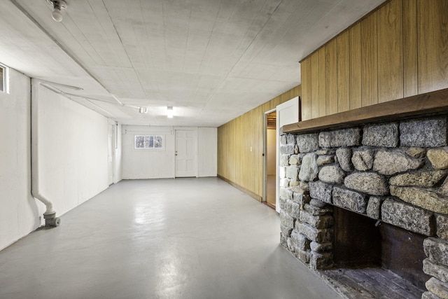 basement featuring wood walls