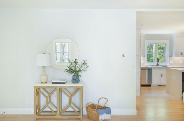 73 Tern Ln, Centerville, MA 02632 - hallway featuring a sink and light wood-type flooring