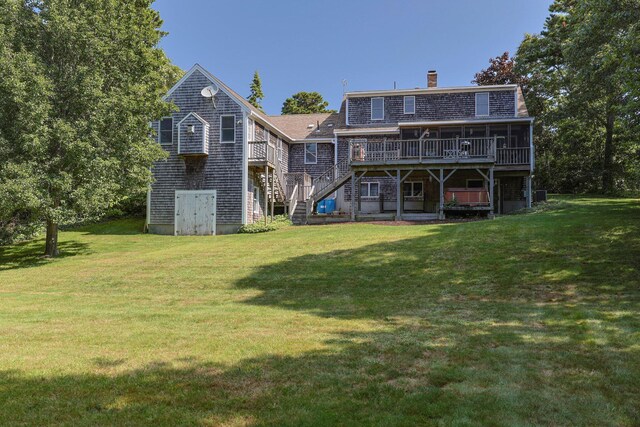 319 Riverview Dr, Chatham, MA 02633 - back of property featuring stairway, a wooden deck, a chimney, and a lawn