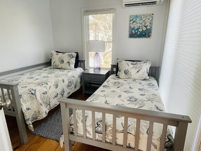 16 Hydrangea Ln, Mashpee, MA 02649 - bedroom with a wall mounted air conditioner and wood finished floors