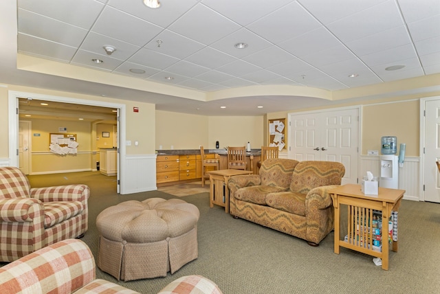 110 Dillingham Ave Unit 212U, Falmouth, MA 02540 - living room with dark carpet, a wainscoted wall, a raised ceiling, bar area, and a paneled ceiling