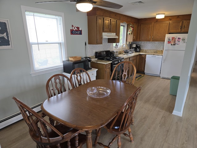 dining area featuring ceiling fan, light wood finished floors, and visible vents